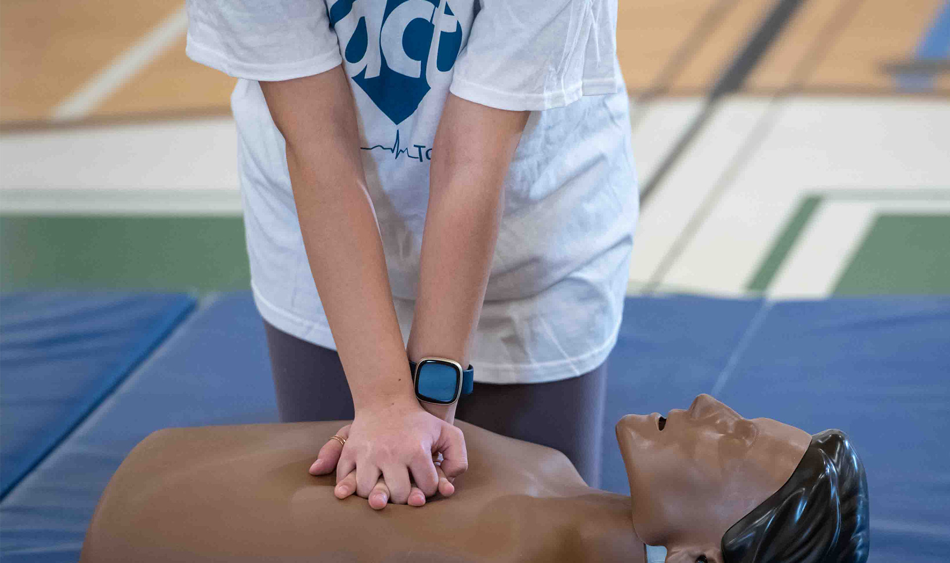 Student practices CPR on mannequin