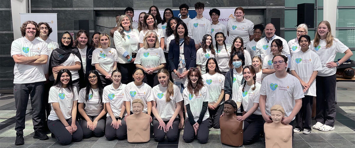 Group photo of the ACT Foundation, AstraZeneca Canada and students with CPR mannequins